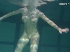 KiloPanties presents: Naked brunette with big tits swims solo